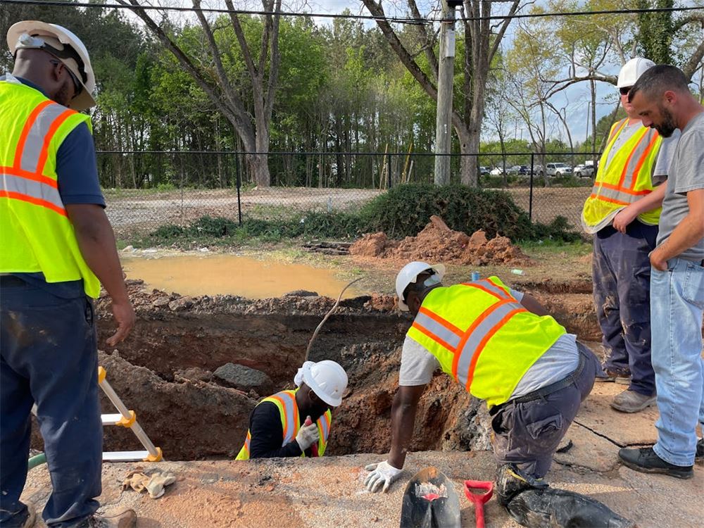 Utility worker inspecting underground water infrastructure